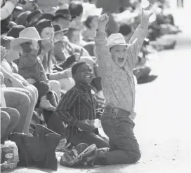  ?? Leah Hennel/calgary Herald ?? Children cheer during the parade kicking off the 101st Calgary Stampede on Friday morning. The two-hour parade featured about 115 entries.