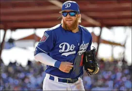  ?? GETTY IMAGES ?? Dodgers third baseman Justin Turner is expected to miss several weeks after his left wrist was broken after being hit by a pitch from the A’s Kendall Graveman.