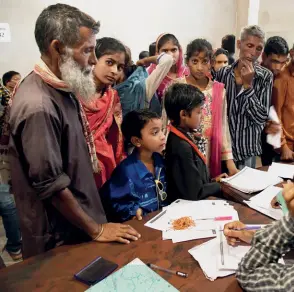  ??  ?? VERIFICATI­ON Officials check documents at an NRC office in Dhubri