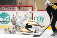  ?? The Associated Press ?? Pittsburgh Penguins goalie Alex D’Orio attempts to block a shot by Jason Zucker (16) during the team’s first practice of the season in Cranberry, Pa. on Thursday.