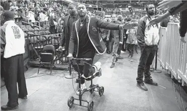  ?? NICK WASS/ASSOCIATED PRESS ?? Wizards guard John Wall greets fans after Washington’s 119-106 victory over the Cavaliers on Friday night.