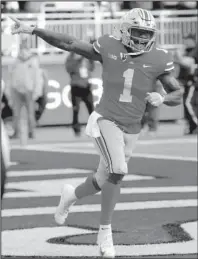  ?? The Associated Press ?? BUCKEYE BLITZ: Ohio State receiver Johnnie Dixon celebrates a touchdown against Michigan Saturday during the second half of the Buckeyes’ 62-39 blowout win over the Wolverines in Columbus, Ohio.