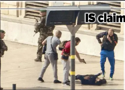  ?? AFP ?? French police point a gun at a man on the ground following a terror attack in Marseille on Sunday.