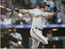  ?? DAVID ZALUBOWSKI — THE ASSOCIATED PRESS ?? The Giants’ Joe Panik drives in a run against Rockies starter Peter Lambert in the second inning. For a report on Tuesday night’s game and more on the Giants, please go to