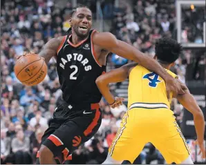  ?? THE CANADIAN PRESS/NATHAN DENETTE ?? Toronto Raptors forward Kawhi Leonard (2) moves around Golden State Warriors guard Quinn Cook (4) during first half NBA action in Toronto on Thursday.