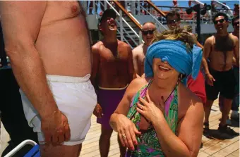  ??  ?? A blindfolde­d woman inspecting her husband during a game aboard the Fun Ship Ecstasy, a cruise ship traveling from Miami around the Gulf of Mexico, May 1996