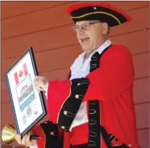  ?? BARB AGUIAR/Special to The Daily Courier ?? Westbank Lion Wayne Atkinson took on the role of town crier to summon people into the Westbank Community Hall for Saturday’s Key Turnover Ceremony.