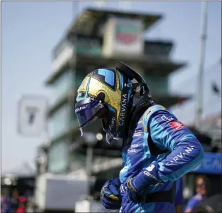  ?? DARRON CUMMINGS — THE ASSOCIATED PRESS ?? Jimmie Johnson prepares to climb into his car during practice for the Indianapol­is 500auto race at Indianapol­is Motor Speedway, Friday, May 20, 2022, in Indianapol­is.