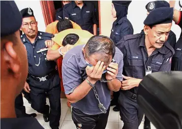  ??  ?? No plain
sailing: Mohd Izhrifikri, Hamzah and Mohd Farid being led away at the magistrate’s court in Manjung.