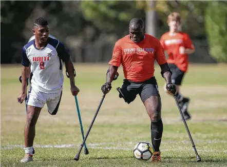  ?? Leslie Plaza Johnson photos ?? Players use crutches for balance in the Texas Regional Amputee Soccer exhibition match between the Haitian National Amputee Soccer Team and Lone Star Amputee Soccer Houston team at Lents Family Park. The Americans beat the ranked Haitians, 6-3.