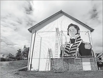  ?? BLADE] [ANDY MORRISON/TOLEDO ?? Scott Hagan paints an image of Commodore Oliver Hazard Perry on the side of an Oak Harbor barn. The project is part of the Ohio History Connection’s plan to have county-themed painted barns throughout Ohio.