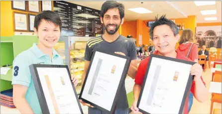  ?? PHOTO: DUNCAN BROWN ?? Angkor Wat Kiwi Bakery &amp; Cafe staff members hold awards won at a recent national competitio­n. From left are Kimsron Khay, Nishant Thakur and Mab Chheur.