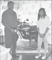  ??  ?? Minister Ramjattan and Sarah Persaud posing with the Hero Motor Bike that is up for grabs in the All-Star category.