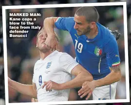  ??  ?? MARKED MAN: Kane cops a blow to the face from Italy defender Bonucci