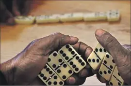  ??  ?? ABRAHAM holds his dominoes. The teams that met in the dining hall of the Abby Apartments came from six of Skid Row Housing Trust’s downtown buildings.