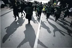  ?? / ALAISTER RUSSELL ?? Members of the ANC Woman’s League march through the streets of Orlando West, Soweto, to lay a wreath at the home of Struggle stalwart Winnie Madikizela-Mandela.