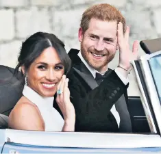  ??  ?? RINGING ENDORSEMEN­T The Duchess of Sussex’s wave as she set off with her husband to the evening reception revealed the emerald cut aquamarine ring that belonged to the late Diana, Princess of Wales, pictured above left in Sydney in 1996.