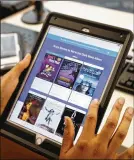  ?? TY GREENLEES / STAFF ?? Dayton Metro Library circulated about 785,000 e-books and electronic audiobooks directly to patrons’ devices in 2018. Publishers fear the surge in lending eats into sales.