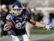  ?? Associated Press ?? UConn’s Kashif Moore catches a pass for a touchdown against South Carolina during the Papajohns.com Bowl on Jan. 2, 2010 in Birmingham, Ala.