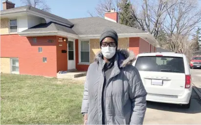  ??  ?? Lakeisha Williams outside her Hazel Crest home, which was boarded up after a shooting Tuesday that left it riddled with bullet holes.