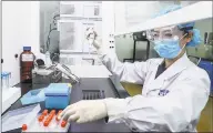  ?? Associated Press ?? A staff member tests samples of a potential COVID-19 vaccine in April at a production plant of SinoPharm in Beijing. The company is boasting that it gave its employees, including top executives, experiment­al shots even before the government OK’d testing in people.