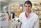  ??  ?? Thailand football league club Navy FC player Toni Dovale poses with a ball at his family’s pharmacy where he is working at the moment in Coruna, northweste­rn Spain. — AFP