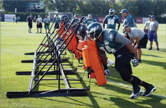  ?? CHRIS SZAGOLA — THE ASSOCIATED PRESS ?? Eagles defensive tackle Connor Wujciak was running be hitting more than just a blocking sled. sled drills with his fellow linemen during practice Tuesday. Starting this weekend, those guys will