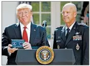  ?? CAROLYN KASTER/AP ?? Gen. John Raymond, who will head U.S. Space Command, joins President Trump on Thursday in the Rose Garden.