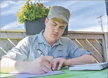  ?? TONY DAVIS/THE GUARDIAN ?? Liam McKenna practises sketching Barabbas, the main character of his web comic, “Release Barabbas,” at Upstreet Craft Brewery in Charlottet­own.