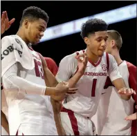  ?? NWA Democrat-Gazette/ANDY SHUPE ?? Arkansas guard Isaiah Joe (1) is congratula­ted by teammates as he comes off the floor against Florida Internatio­nal on Saturday at Walton Arena in Fayettevil­le. Joe led the Razorbacks with 34 points in 28 minutes.