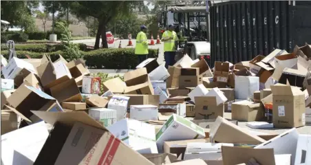 ?? Trevor Morgan/the Signal ?? Crews work to clean up the boxes left after the city of Santa Clarita’s Shred Event at The Centre on Saturday.