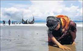  ?? REUTERS ?? A Rohingya refugee touches the shore after crossing the Bangladesh­Myanmar border by boat.