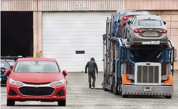  ??  ?? End of the road: An employee loads cars onto a trailer at the GM Lordstown plant, in Ohio. GM said it would end production at five North American plants including Lordstown. — AFP