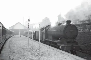  ?? W S Sellar ?? Bucking the diesel trend, as well as coming from ‘the wrong side of the tracks’ in regard to its non-CR/LMS heritage, we find Gresley ‘J39’ class 0-6-0 No 64946 on passenger work at the former CR station of Leith North on 19 March 1960. The goods and passenger routes ran in parallel east of Newhaven before reaching the edge of the Firth of Forth, and then immediatel­y the passenger route curved inland and soon terminated here. Meanwhile, immediatel­y north of here a network of lines splayed out to serve West Old Dock, East Old Dock, Victoria Dock and reach across a swing bridge that crossed the Inner Harbour (effectivel­y at the end of the Water of Leith) to reach more docks. Immediatel­y above the ‘J39’ is Lindsay Road, which from 1905 until 1956 was on a direct electric tram route into Edinburgh, less than two miles distant – stiff competitio­n against a far from direct branch line of 5½ miles. It was ultimately left to modern diesel units to battle against modern buses for the business.