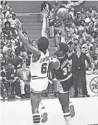  ?? ?? Johnson ( Isaiah) played center and takes a shot against Julius Erving in Game 6 of the 1980 NBA Finals.