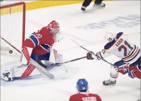  ?? Ryan Remiorz / Associated Press ?? Edmonton’s Dominik Kahun scores the winning goal on Montreal goaltender Cayden Primeau during overtime on Wednesday. The Oilers won 4-3 to spoil Montreal’s regular-season finale.