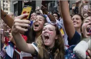  ?? CRAIG RUTTLE - THE ASSOCIATED PRESS ?? Fans celebrates as members of the the U.S. women’s soccer team pass by during a ticker tape parade along the Canyon of Heroes, Wednesday, July 10, 2019, in New York. The U.S. national team beat the Netherland­s 2-0 to capture a record fourth Women’s World Cup title.