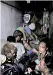  ??  ?? People inside a hidden room at Manila police Drug Enforcemen­t Unit