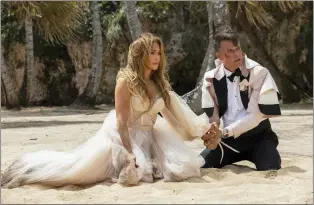  ?? LIONSGATE VIA AP ?? Jennifer Lopez, left, and Josh Duhamel in a scene from “Shotgun Wedding.”