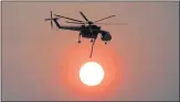  ?? KARL MONDON — STAFF PHOTOGRAPH­ER ?? A helicopter works late in the day fighting the Carr Fire in Igo.