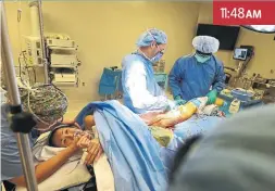  ??  ?? Anesthesia assistant Angela Chan begins to wake Noguchi after the surgery.