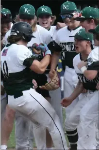  ?? ?? Waterford Kettering’s Logan Van Sicklen, left, is greeted at home plate after hitting a solo home run to open the scoring in a Division 1predistri­ct loss to Clarkston at Oxford on Tuesday.