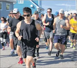  ?? CHRIS SHANNON/CAPE BRETON POST ?? About 80 runners push toward Seaview Drive from the Northern Yacht Club in North Sydney on Sunday. It was the first year for the Bartown Festival’s fun run to be named the Carmen Young 5K Road Race. Young’s parents, Brian and Nancy, were on hand to wish the runners well. Jason McGuigan of Sydney won with an unofficial time of 20 minutes and 30 seconds.