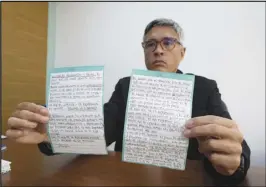  ?? ARIANA CUBILLOS/AP ?? Jesus Loreto, an attorney representi­ng Tomeu Vadell, one of six US oil executives jailed for three years in Venezuela, shows a letter written by Vadell on Wednesday in Caracas, Venezuela.