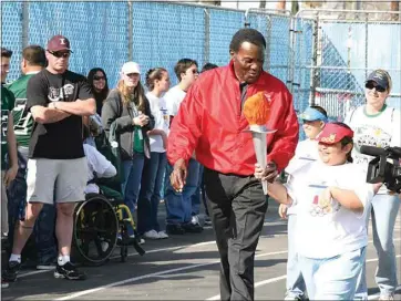  ?? See more photos at Bakersfiel­d.com. COURTESY OF BCSD ?? Olympic decathlete Rafer Johnson walks the track with Bakersfiel­d City School District students during the annual Rafer Johnson Day.