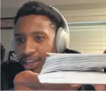  ??  ?? During a video media conference on Thursday, Broncos receiver Courtland Sutton holds up the tablet he is using to take notes while learning the team’s new playbook.