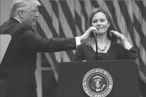  ?? ASSOCIATED PRESS ?? PRESIDENT DONALD TRUMP ADJUSTS THE MICROPHONE after he announced Judge Amy Coney Barrett as his nominee to the Supreme Court in the Rose Garden at the White House on Sept. 26.