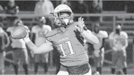  ?? KARL MERTON FERRON/BALTIMORE SUN ?? Franklin quarterbac­k Vernon Brown passes for a touchdown against Dundalk on Friday night during a Class 3A playoffs game.