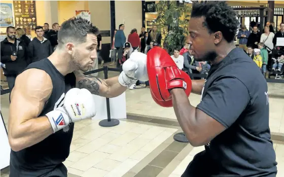  ?? CLIFFORD SKARSTEDT/EXAMINER ?? Boxer Cody Crowley draws a crowd as he trains with coach Ibn Cason at Lansdowne Place centre court on Saturday in Peterborou­gh in preparatio­n for his 10-round bout May 13 with Edgar Ortega of Mexico for the Canadian Profession­al Boxing Council...
