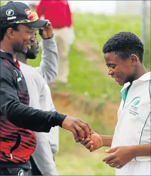  ?? Picture:SIBONGILE NGALWA ?? HAND IT TO HIM: Solomon Mahlangu High School bowler Awodwa Mzwali, right, receives some helpful tips from Warriors coach Malibongwe Maketa at Winter Rose Park, NU13 Mdantsane, on Tuesday afternoon